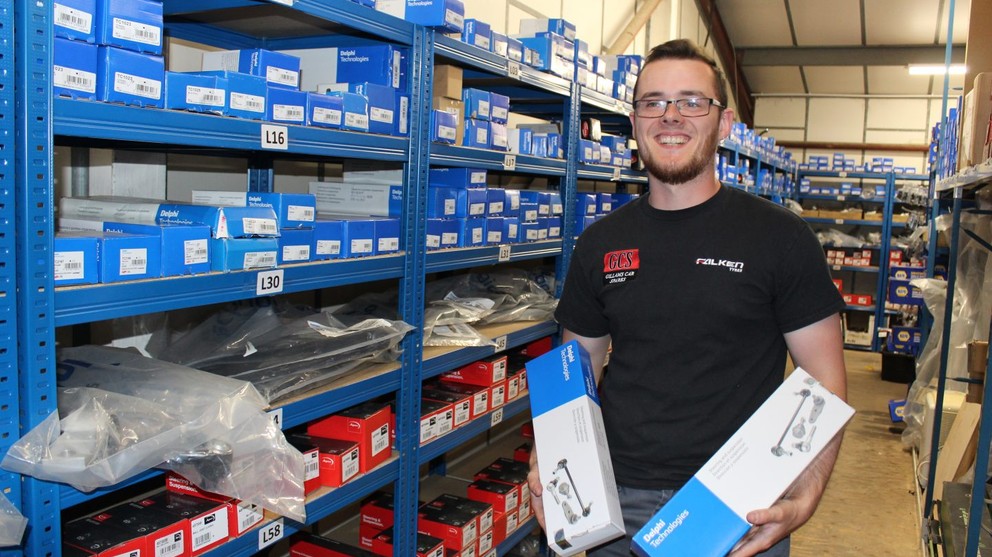 Shop member holding a product in each hand