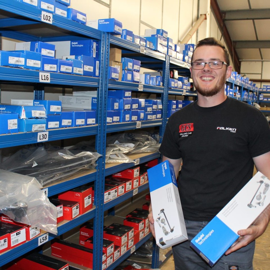 Shop member holding a product in each hand