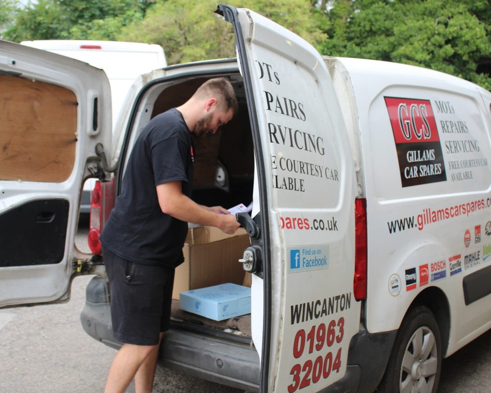 A Gillams staff member looking in the back of his van